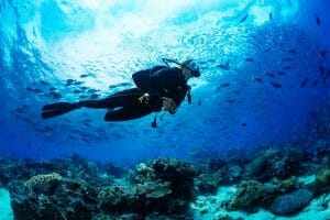 A diver exploring colorful coral reefs in the waters of Naxos.