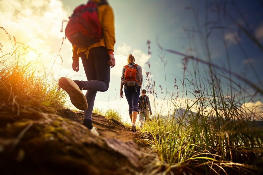 Activities in Naxos. A hiking trail in Naxos leading to a medieval tower amid scenic landscapes.