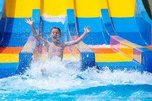 Children enjoying a waterslide near Agios Prokopios Beach in Naxos."